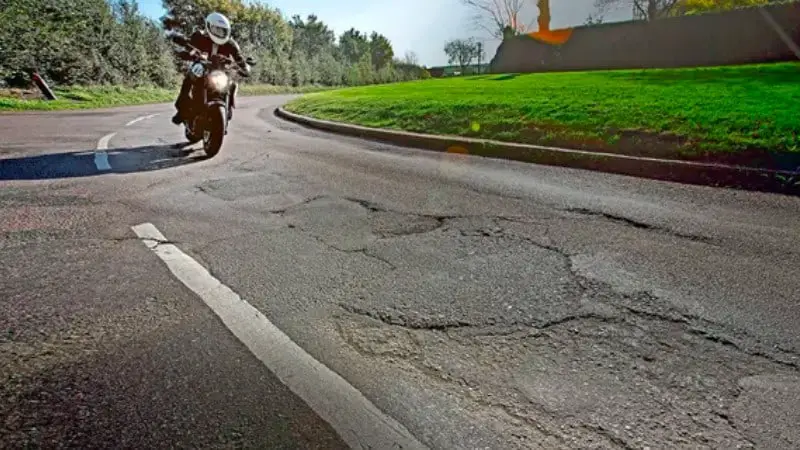 Motorcycle ride on road potholes
