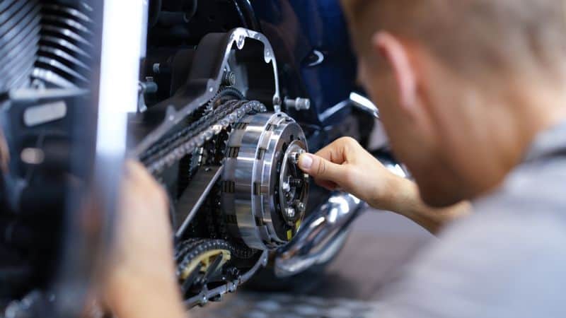 Man repaining a Motorcycle with spanner